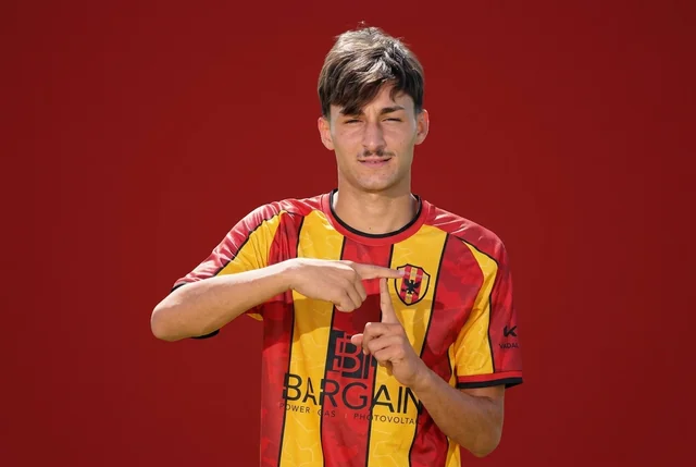 Pasquale Faccetti indica con entrambe le mani lo stemma della Nuova Igea Virtus sulla maglia giallorossa